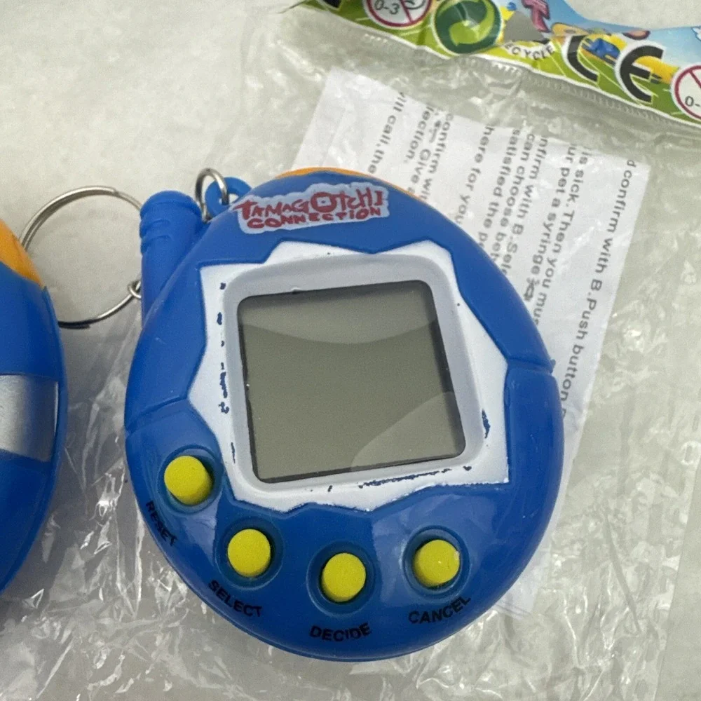 2 Collectors Tamagotchi With Crack On Plastic On Right Side Still Works